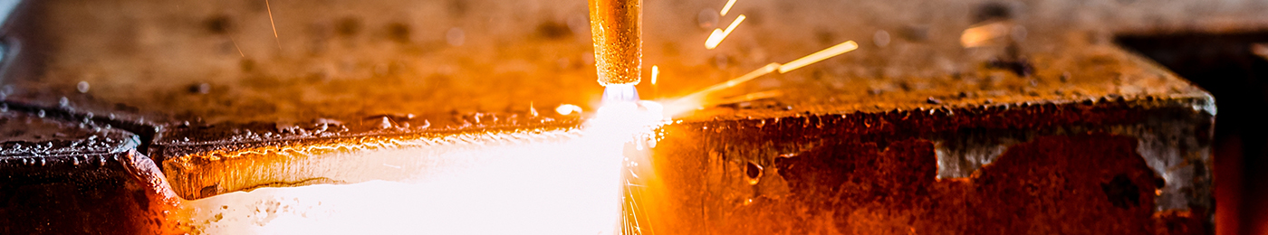 metal slab being cut by gas welder